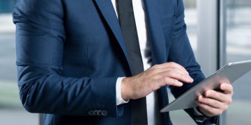 A businessman using a tablet in a business setting